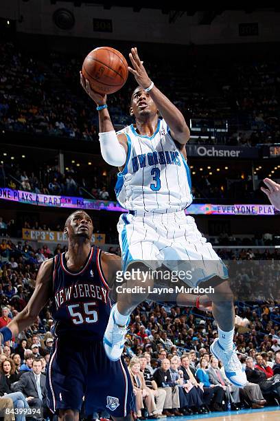 Chris Paul of the New Orleans Hornets shoots over Keyon Dooling of the New Jersey Nets on January 21, 2009 at the New Orleans Arena in New Orleans,...