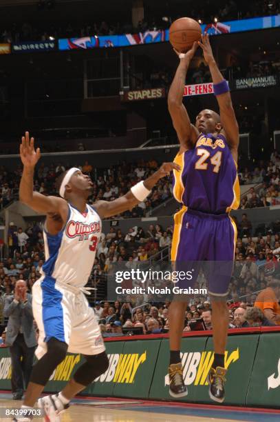 Kobe Bryant of the Los Angeles Lakers shoots against Ricky Davis of the Los Angeles Clippers at Staples Center on January 21, 2009 in Los Angeles,...