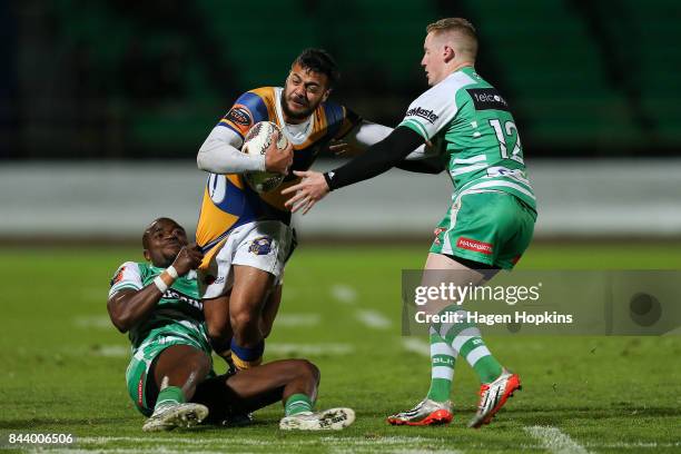 Chase Tiatia of Bay of Plenty is tackled by Willy Ambaka and Hamish Northcott of Manawatu during the round four Mitre 10 Cup match between Manawatu...