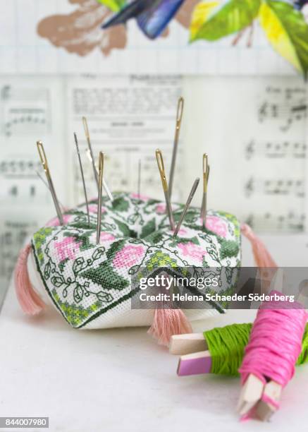 pin cushion with sewing needles - cross stitch stock pictures, royalty-free photos & images