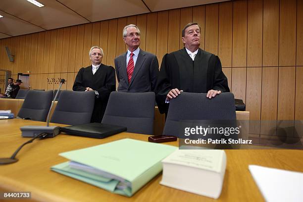 Klaus Zumwinkel, former CEO of Deutsche Post AG , stands with his lawyers Rolf Schwedhelm and Hanns Feigen in the courtroom of the county court...