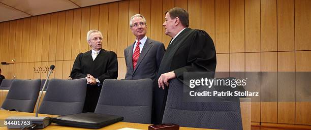 Klaus Zumwinkel, former CEO of Deutsche Post AG , stands with his lawyers Rolf Schwedhelm and Hanns Feigen in the courtroom of the county court...