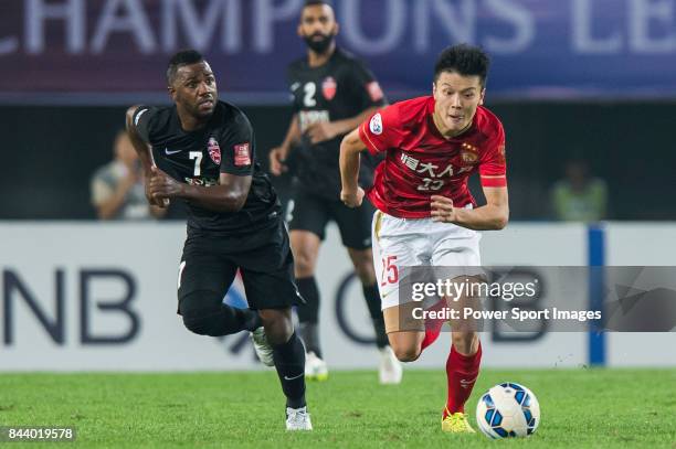 Guangzhou Evergrande midfielder Zou Zheng fights for the ball with Al Ahli forward Ismail Al Hammadi during the AFC Champions League Final Match 2nd...