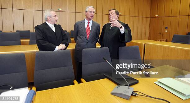 Klaus Zumwinkel, former CEO of Deutsche Post AG , stands with his lawyers Rolf Schwedhelm and Hanns Feigen in the courtroom of the county court...