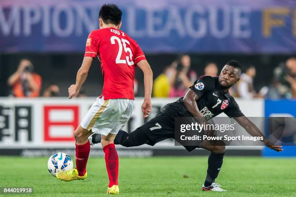 Al Ahli forward Ismail Al Hammadi fights for the ball with Guangzhou Evergrande midfielder Zou Zheng during the AFC Champions League Final Match 2nd...