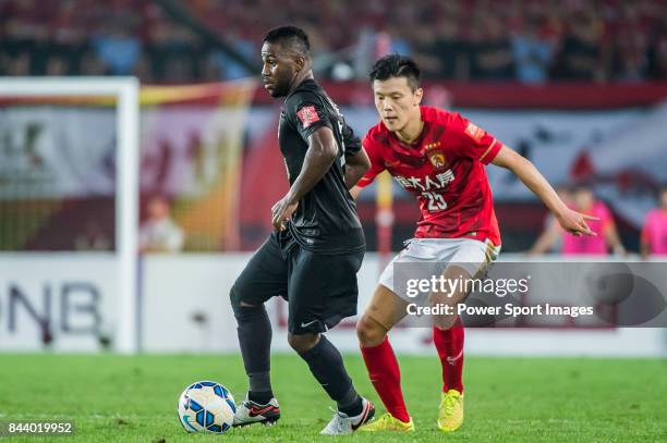 Al Ahli forward Ismail Al Hammadi fights for the ball with Guangzhou Evergrande midfielder Zou Zheng during the AFC Champions League Final Match 2nd...