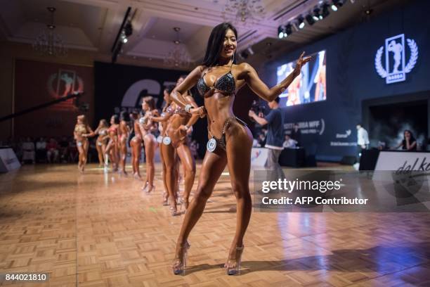 In this photo taken on September 2 fitness models compete in the 2017 NABBA WFF Asia Seoul Open Bodybuilding Championship in Seoul. / AFP PHOTO / Ed...