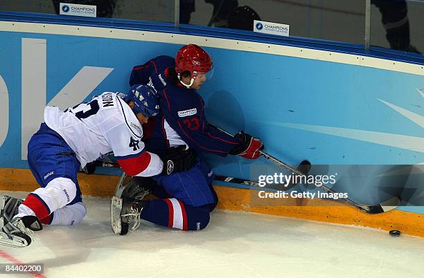 Stanislav Chustov of Metallurg Magnitogorsk challenges Jan Alston of ZSC Lions Zurich during the IIHF Champions Hockey League final game between...