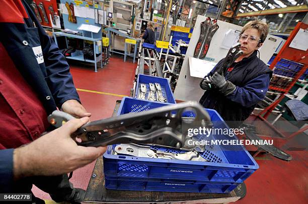 Employees work on the production line of a factory of the European car parts maker, British Wagon automotives, on January 22, 2009 in Orbec, northern...