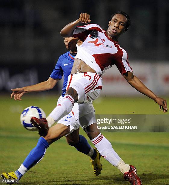 United Arab Emirates team forward Ahmed Khalil Sebait Mubarak shoots for his team's fifth goal against Malaysia after dodging Norhafiz Zamani during...
