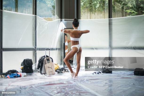 In this photo taken on September 2 a model poses backstage prior to competing in the 2017 NABBA WFF Asia Seoul Open Bodybuilding Championship in...