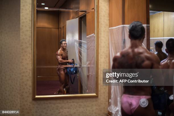 In this photo taken on September 2 a bodybuilder walks backstage prior to competing in the 2017 NABBA WFF Asia Seoul Open Bodybuilding Championship...