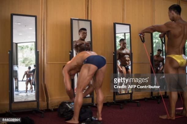 In this photo taken on September 2 bodybuilders prepare backstage prior to competing in the 2017 NABBA WFF Asia Seoul Open Bodybuilding Championship...