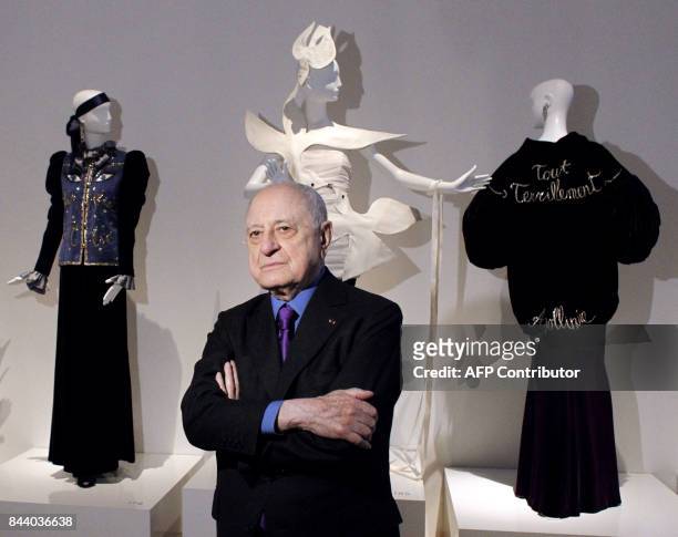 Major retrospective for fashion genius Saint Laurent French businessman and head of Sidaction organisation Pierre Berge poses in front of models...
