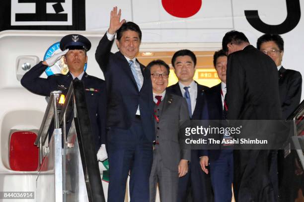 Japanese Prime Minister Shinzo Abe waves on departure at Vladivostok International Airport on September 7, 2017 in Artyom, Russia. Abe is in Russia...