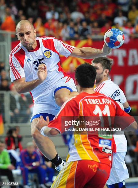 Russia's Konstantin Igropulo shoots next to Macedonia's Pavel Atman during the Men's World Handball Championship Croatia 2009 Group C match in...