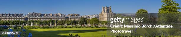 the louvre and the houses along rue de rivoli from jardin des tuileries - jardin des tuileries stock pictures, royalty-free photos & images