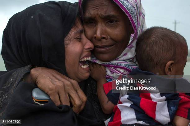 Rohingya Muslim refugees react after being re-united with each other after arriving on a boat from Myanmar on September 08, 2017 in Whaikhyang...