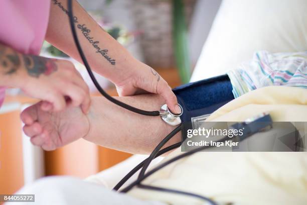 Eberswalde-Finow, GERMANY A geriatric nurse measures a resident's blood pressure on August 08, 2017 in Eberswalde-Finow, Germany.