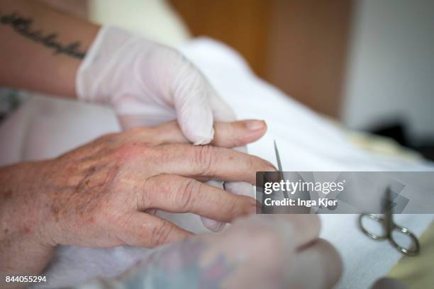 Eberswalde-Finow, GERMANY A geriatric nurse files a resident's fingernail on August 08, 2017 in Eberswalde-Finow, Germany.