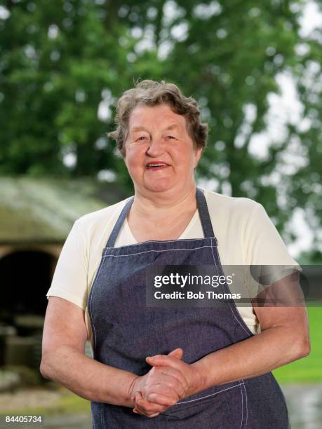 Mature woman in a farmyard, smiling