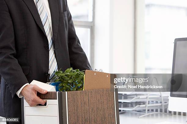 businessman carrying file box of belongings - box file stock pictures, royalty-free photos & images