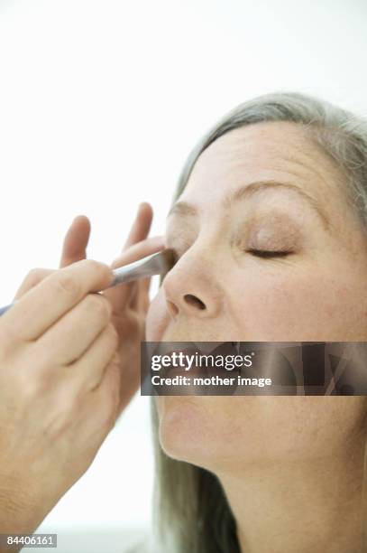 mature woman having make over - beautiful woman over 50 stock pictures, royalty-free photos & images