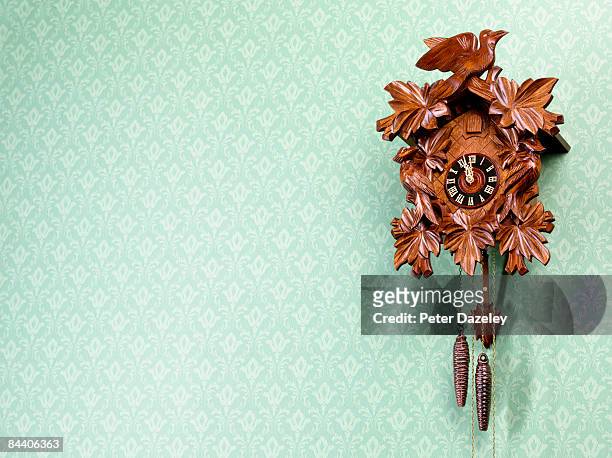 cuckoo-clock against wallpapered wall - old clock stock pictures, royalty-free photos & images