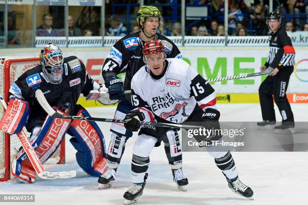 Sebastian Dahm of Iserlohn , Alexander Bonsaksen of Iserlohn , Travis James Mulock of Koeln battle for the ball during a friendly match between...