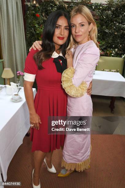 Salma Hayek and Sienna Miller attend the mothers2mothers Host Committee Breakfast at Mark's Club on September 7, 2017 in London, England.