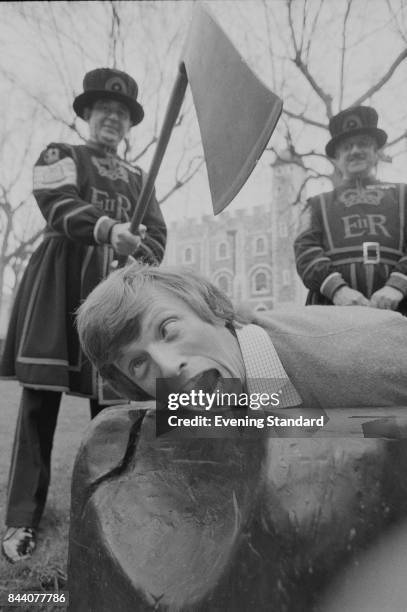 English entertainer Tommy Steele pretends to be decapitated by two Yeomen Warders at the Tower of London, London, UK, 5th April 1978.