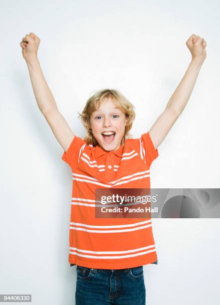 boy (10-11) cheering, arms up, smiling - arms raised stock pictures, royalty-free photos & images