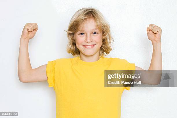 boy (10-11) flexing muscles, smiling, portrait - child white stock pictures, royalty-free photos & images