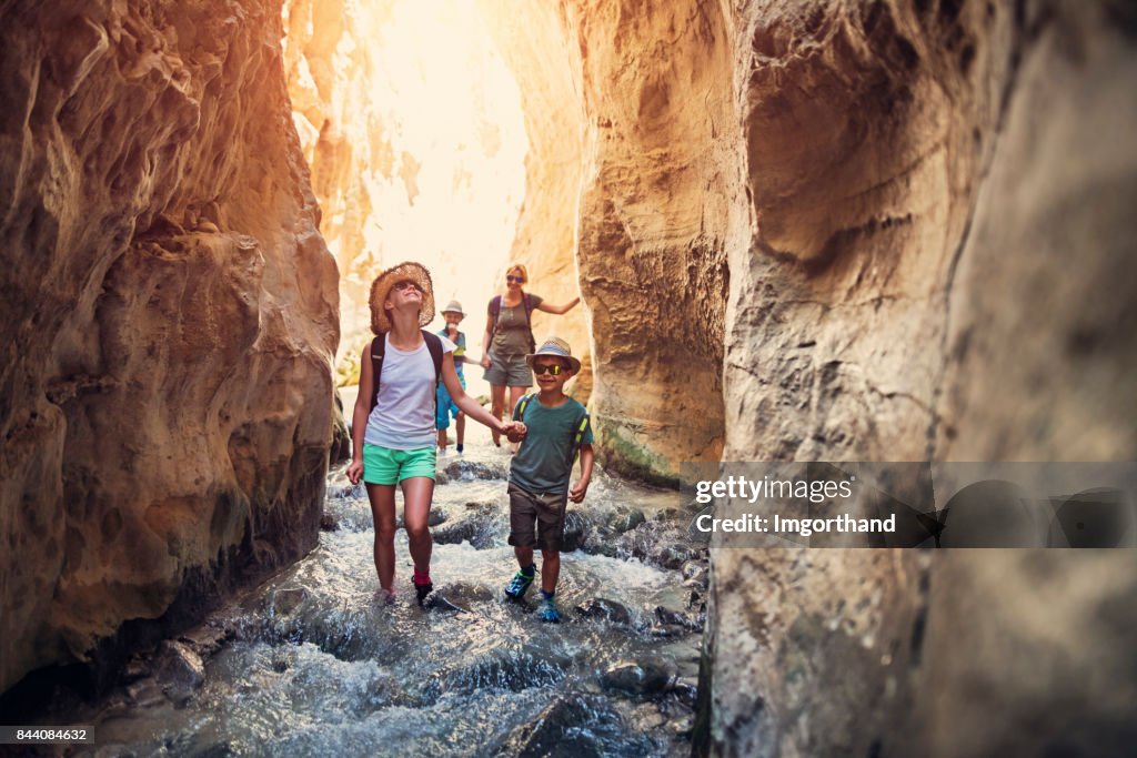Family hiking through rivier in Andalusia, Spain