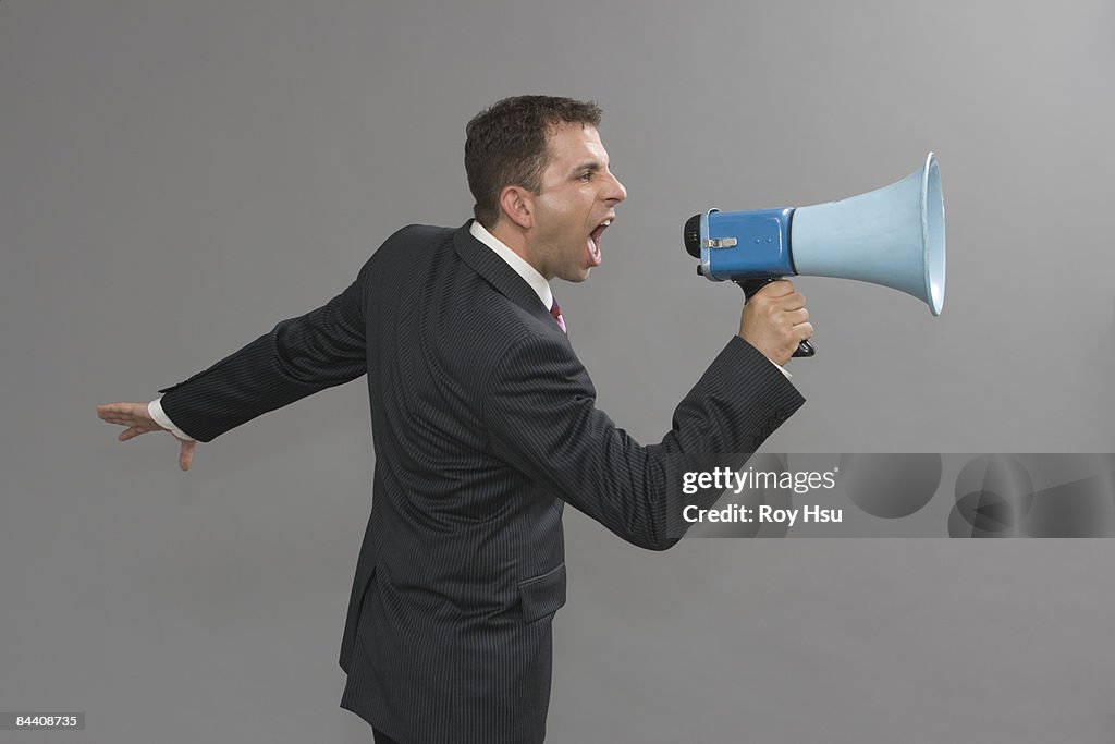 Profile of Caucasian business man with megaphone