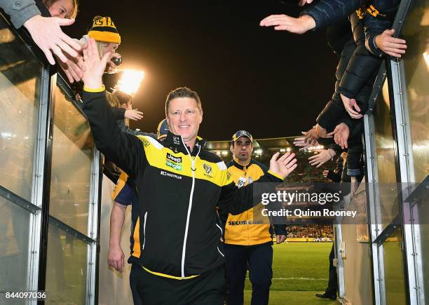 Tigers head coach Damien Hardwick high fives fans after winning the AFL Second Qualifying Final Match between the Geelong Cats and the Richmond...