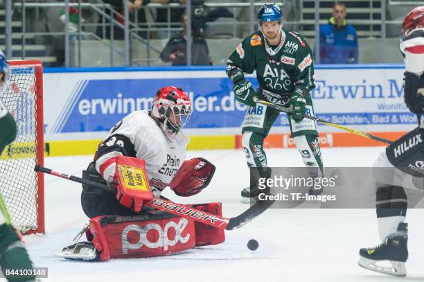 Daniar Dshunussow of Koelner Haie and Drew LeBlanc of Augsburger Panther battle for the ball during a friendly match between Augsburger Panther and...