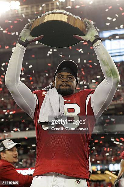 Arizona Cardinals linebacker Karlos Dansby holds up the Halas trophy after the NFC Championship game against the Philadelphia Eagles at University of...