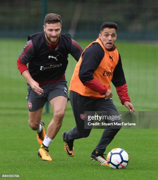 Shkodran Mustafi and Alexis Sanchez of Arsenal during a training session at London Colney on September 8, 2017 in St Albans, England.
