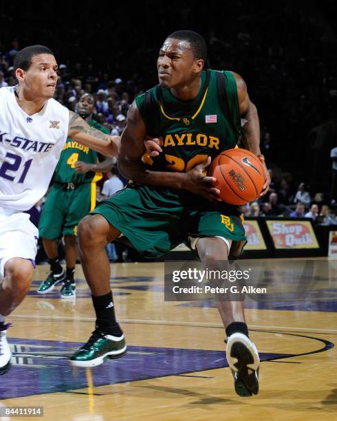 LaceDarius Dunn of the Baylor Bears drives against pressure from Denis Clemente of the Kansas State Wildcats on January 21, 2009 at Bramlage Coliseum...