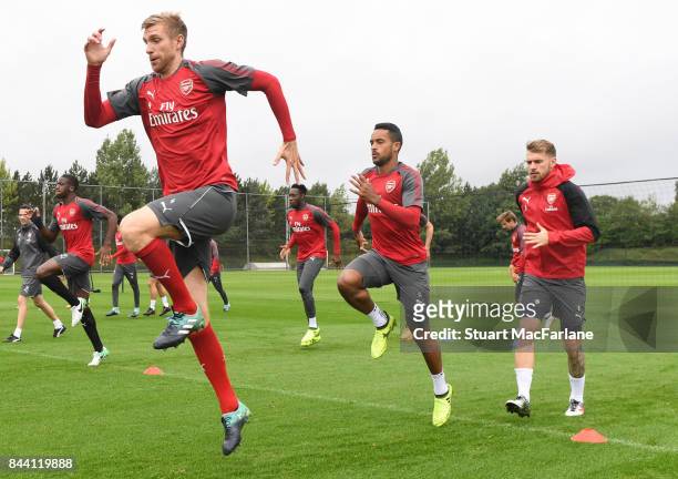 Per Mertesacker, Theo Walcott and Aaron Ramsey of Arsenal during a training session at London Colney on September 8, 2017 in St Albans, England.