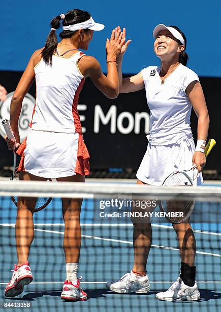 Zheng Jie and partner Yan Zi of China react in their game against Klaudia Jans and Alicja Rosolska, both of Poland, during their women's doubles...