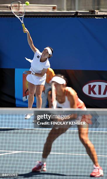 Zheng Jie serves as her partner Yan Zi of China looks on in their game against Klaudia Jans and Alicja Rosolska, both of Poland, during their women's...