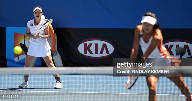 Yan Zi of China returns the ball as partner Zheng Jie looks on in their game against Klaudia Jans and Alicja Rosolska, both of Poland, during their...