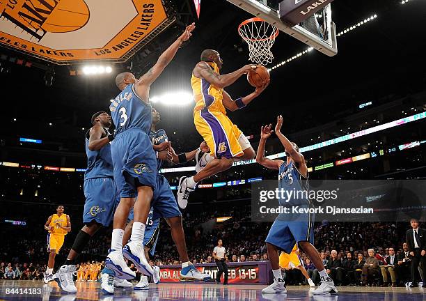 Kobe Bryant of the Los Angeles Lakers drives to the basket against Caron Butler and Dominic McGuire of the Washington Wizards during the first...