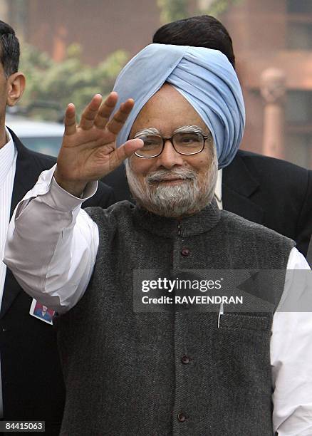 This photo taken on December 10 shows Indian Prime Minister Manmohan Singh waving upon his arrival at Parliament house in New Delhi to attend the...