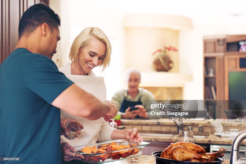 Couple prepararing thanksgiving dinner
