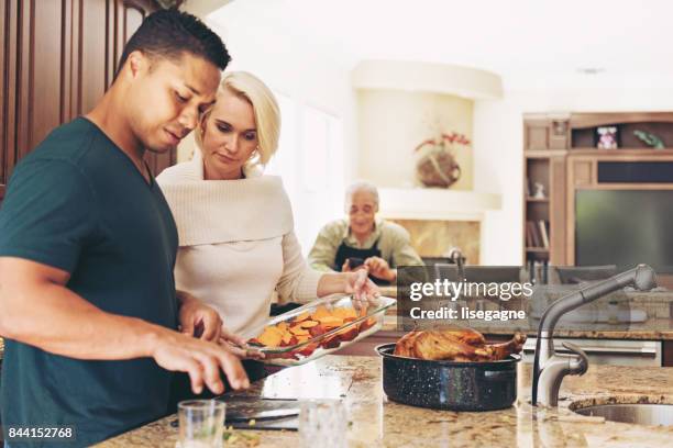 couple prepararing thanksgiving dinner - cooker dial stock pictures, royalty-free photos & images