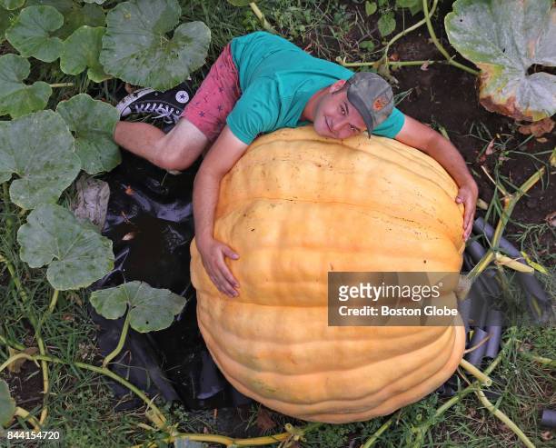 Revere resident Christian Ilsley poses with the giant pumpkin he is growing in his backyard in Revere, MA on Sep. 6, 2017. He plans to hollow it out,...