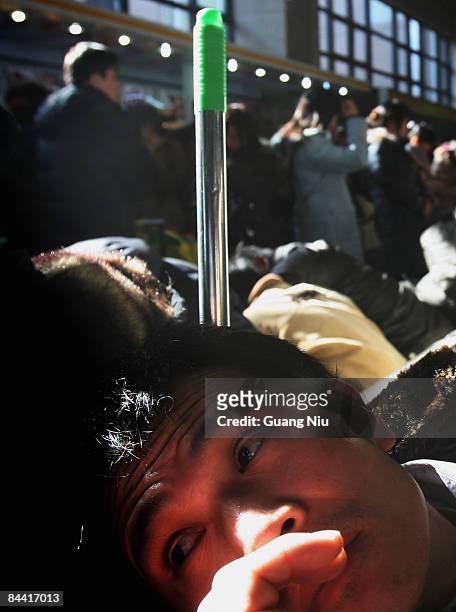 Passengers wait to board a train at Beijing West Railway Station on January 23, 2009 in Beijing, China. Millions of Chinese people are heading back...
